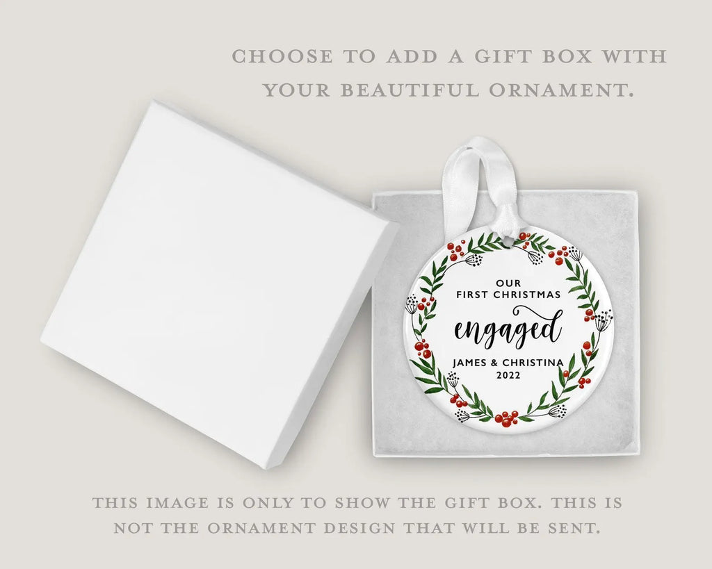 a gift box with a white ornament inside, which has a message about an engagement announcement.